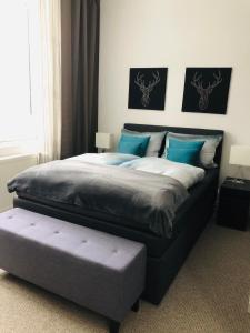 a bedroom with a large bed with blue pillows at Villa Waidhof in Schierke