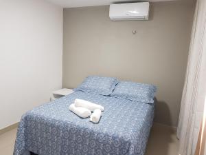 a bedroom with a bed with two towels on it at Beach Place Aquiraz Riviera in Aquiraz +21 photos