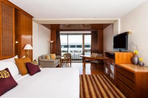 a hotel room with a bed and a television at Amari Don Muang Airport Bangkok in Bangkok