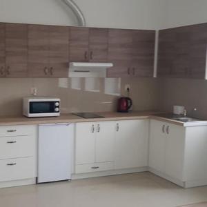 a kitchen with white cabinets and a microwave at Lula in Gołdap