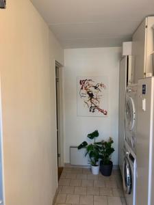a laundry room with a washing machine and a tile floor at Beautiful location Copenhagen/Malmö in Malmö