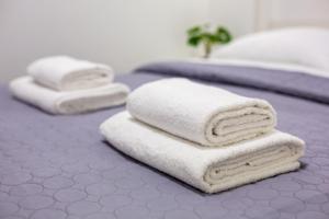 two beds with white towels on top of them at Cozy apartments center in Lviv +63 photos