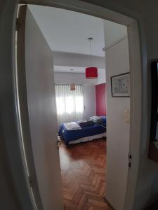 a room with a bedroom with a bed in it at Dormitorios La Lucila Vicente Lopez Sol & Tren in La Lucila