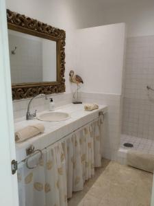 a bathroom with a sink and a mirror at Mi casa su casa in La Oliva