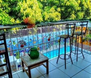 a balcony with a table and chairs and a pool at Casa de Mony in Santa Marta