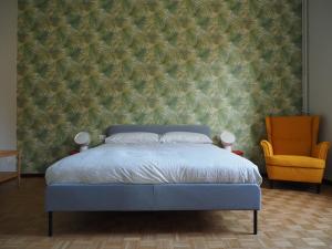 a bedroom with a blue bed and a wall at Casetta SAFILU' in Milan