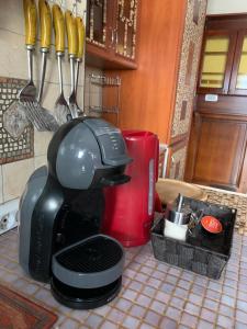 a coffee maker sitting on a kitchen counter with utensils at Villa Edelweiss in Sveti Stefan