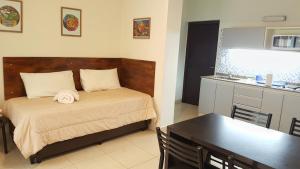 Cet appartement comprend une chambre avec un lit et une table ainsi qu'une cuisine. dans l'établissement Pachamama - Depto p/4 nuevo y a 5' del centro, à Salta
