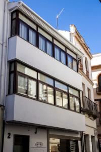 an apartment building with black and white windows at Tándem House in Priego de Córdoba