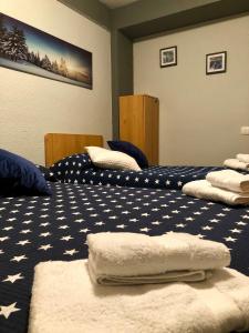 a room with two beds with towels on them at Anayet Sweet Home in Formigal