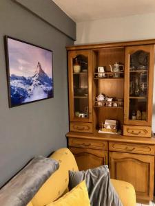 a living room with a picture of a mountain on the wall at Anayet Sweet Home in Formigal