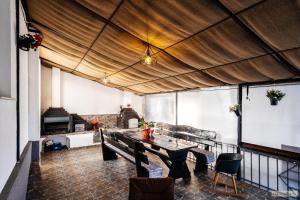 a dining room with a table and a couch at Sweet Home Bucovina- Baza perfecta pentru explorarea Bucovinei in Frasin