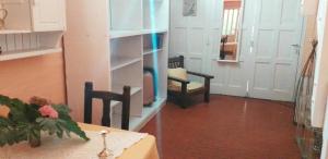 a room with a table and two chairs and a door at L&L Sur in Mar del Plata