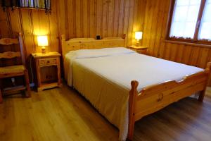 ein Schlafzimmer mit einem Bett und zwei Nachttischen in der Unterkunft Sportrama 115 in Verbier