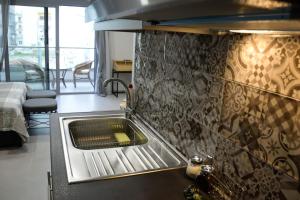 a kitchen with a stainless steel sink in a room at Dreamstudio in the city center in Volos