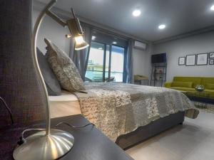 a bedroom with a bed with a lamp on it at Dreamstudio in the city center in Volos