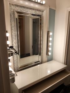 a bathroom with a mirror and a white counter at Belfast Town House in Belfast