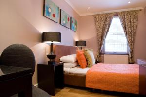 a bedroom with a large bed and a large window at New Linden Hotel in London