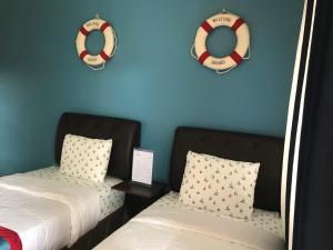 two beds with life preservers and two lifesavers at ANCHORAGE INN Moalboal in Moalboal