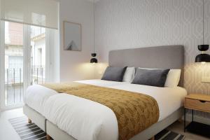 a bedroom with a large bed and a large window at ARRASATE SUITE Stylish, Super Central and New. in San Sebastián