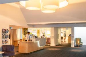 a man standing at a counter in a lobby at Scenic Hotel Marlborough in Blenheim +44 photos
