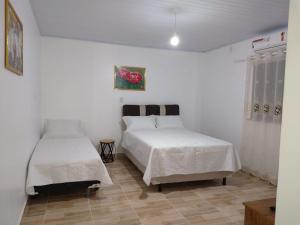 Un pat sau paturi într-o cameră la Pousada Solar Encanto do Marajó