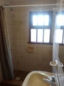 a bathroom with a bath tub and a window at Cabaña Ostende in Ostende