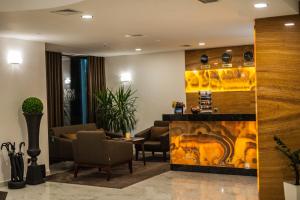 a lobby with a waiting room with chairs and a fireplace at Bernardazzi Grand Hotel in Chişinău +119 photos