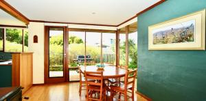 a dining room with a wooden table and chairs at Cowrie Chalet in Augusta