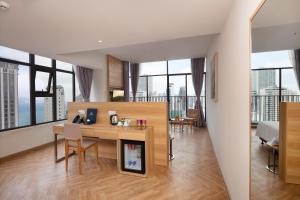 a kitchen and living room with a table and chairs at VENTANA NHA TRANG HOTEL in Nha Trang