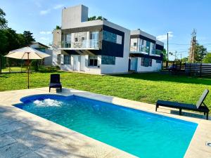 una casa con piscina frente a una casa en Donaire en Pergamino