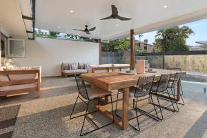 a dining room with a wooden table and chairs at Walk to Hastings Street, Noosa Sound in Noosa Heads