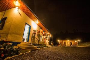 a building with lights on the side of it at night at Hotel Bariloche in Santa Rosa de Cabal