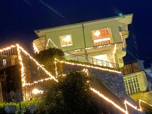 a building with christmas lights on it at night at Villa Spring Acre in Nuwara Eliya