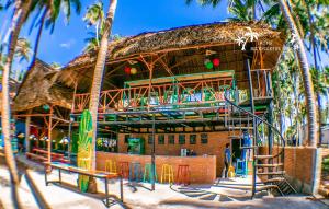 a resort on the beach with palm trees at iHome Backpacker Resort in Mui Ne