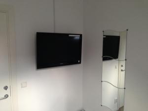 En tv och/eller ett underhållningssystem på Pizza House Bed Simrishamn