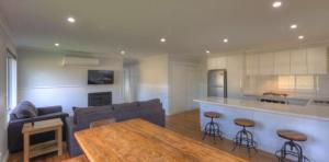 a living room with a couch and a table at Yarrawonga Holiday Park in Yarrawonga