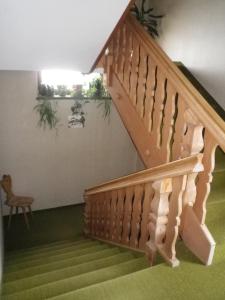 a wooden staircase in a house with potted plants at Pension Rainhof in Santa Maddalena