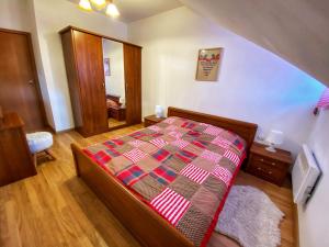 a bedroom with a bed with a colorful comforter at Papa Moose Pamporovo in Pamporovo