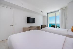 a hotel room with two beds and a television at Amazing views on the 29th floor 2BR Beach Resort in Hallandale Beach +35 photos