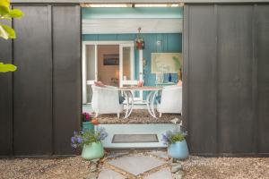 an open door to a patio with a table and chairs at Annies B and B in Warkworth