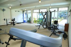 a gym with several treadmills and machines in a room at Hillview Apartments in Kampala