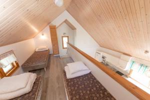 a attic room with two beds and a staircase at Yyteri Holiday Cottages in Pori