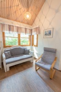 a living room with a couch and a chair at Yyteri Holiday Cottages in Pori