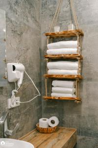 a bunch of towels on a towel rack in a bathroom at New Gudauri Atrium Apartment 202 in Gudauri