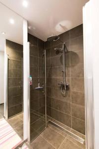 a bathroom with a shower with a glass door at Zee-en-Zo Noordwijk in Noordwijk