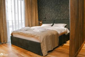 a bedroom with a large bed with white pillows at New Gudauri Atrium Apartment 202 in Gudauri