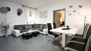 a living room with a couch and a table at Haus Renè in Villach