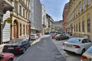 a city street with cars parked on the street at S23 in Budapest