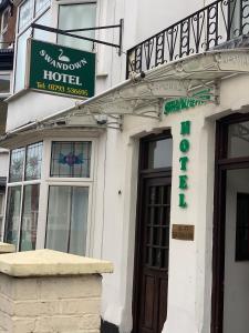 a building with a sign for a hotel at Swandown Hotel in Swindon